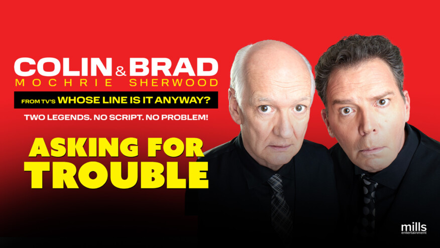 Two men in black shirts and patterned ties stare into the camera. Text reads, 