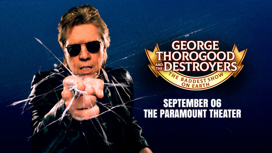 A man in a leather jacket and sunglasses points to the viewer, as if breaking glass. Text reads,