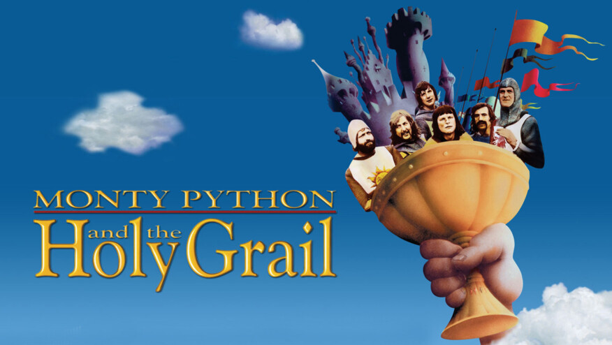 A hand holds a goblet to a blue and cloudy sky. In the goblet, there are six men in Arthurian outlets, flags, and a castle. Text reads, 