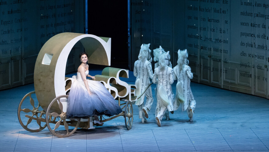 A woman rides on a carriage made of out of a word. The 