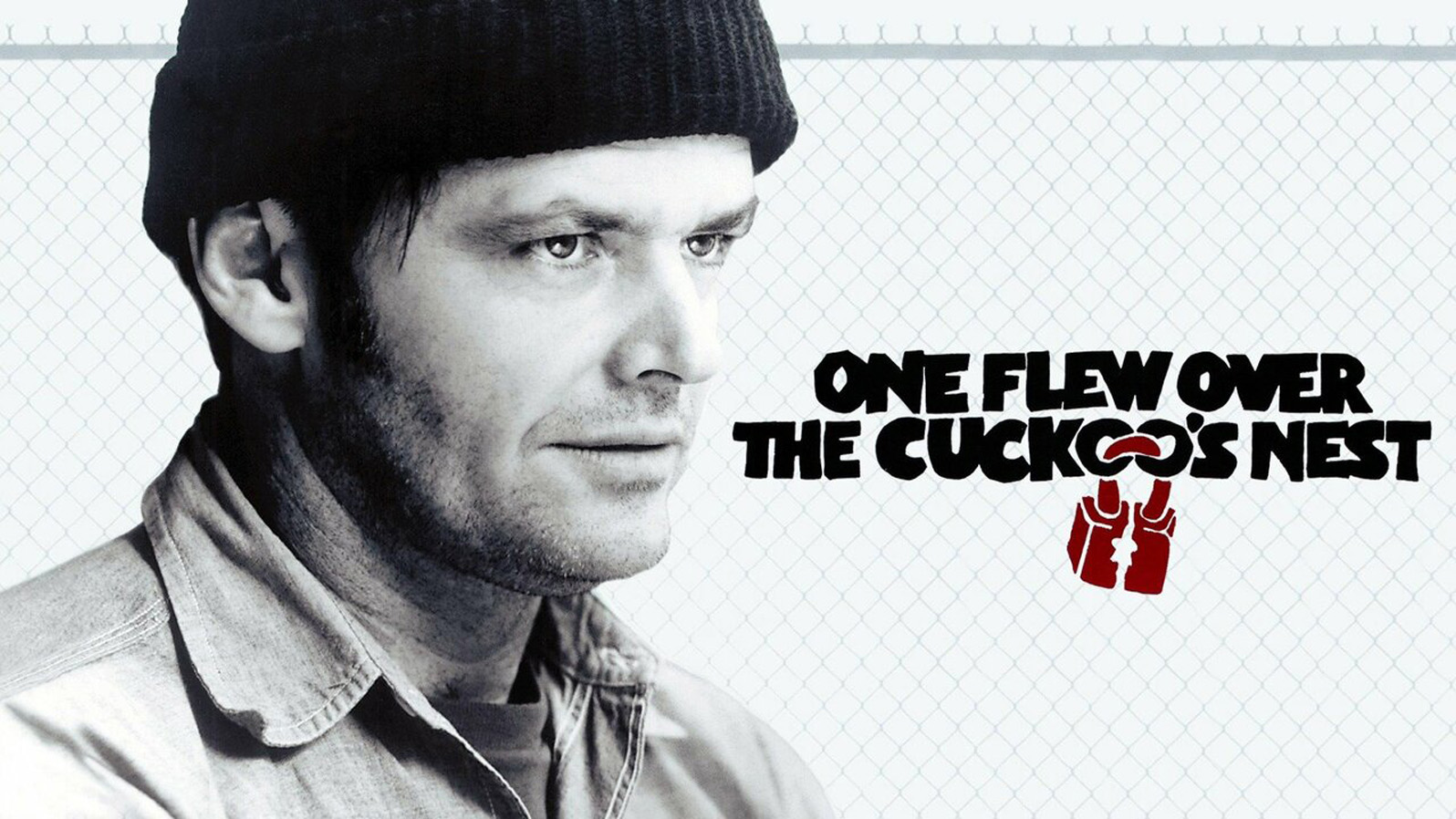 A man in a fisherman beanie in front a chain link fence. Text reads 