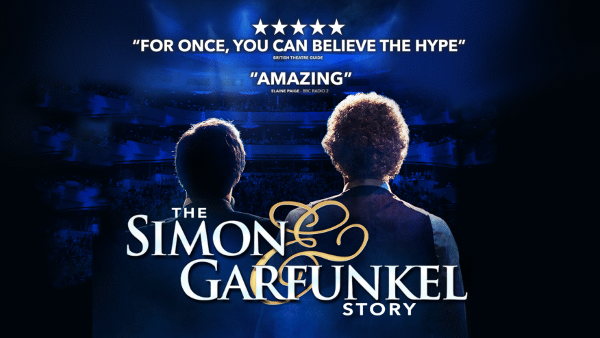 The back of two men in front a shining crowd. Text reads, 