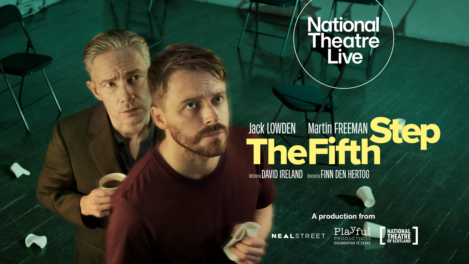 Two men in a room with chairs, clutching cups and looking into the distance. Text reads, 