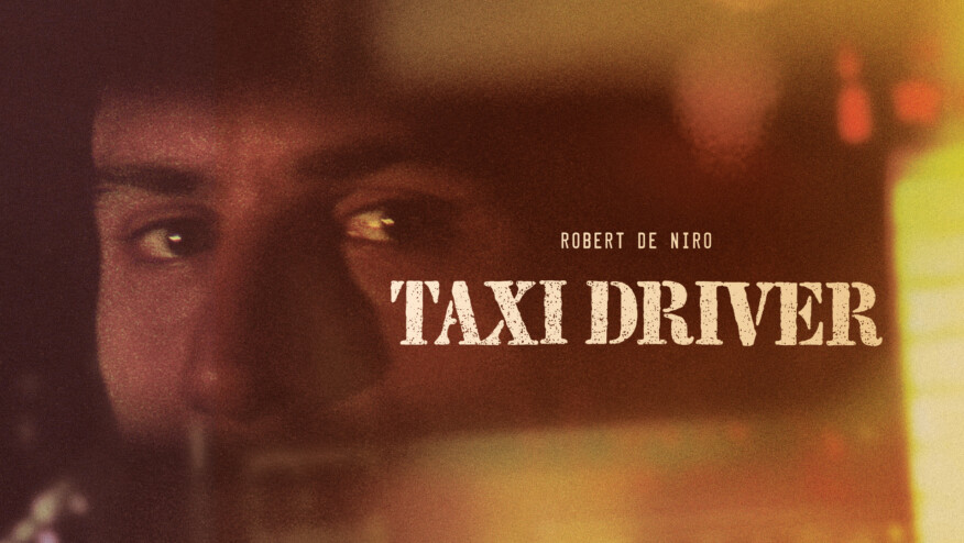 A nervous-looking man stands on a city street with a taxi behind him. Text reads, 